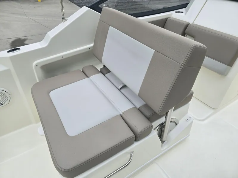 Slide: The Image of 2025 Boston Whaler 210 Vantage boat seat, featuring beige and white cushioned upholstery. - 11
