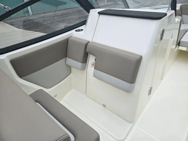 Slide: The Image of 2025 Boston Whaler 210 Vantage interior seating with beige upholstery and modern design. - 12