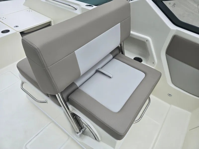 Slide: The Image of 2025 Boston Whaler 210 Vantage boat seat, featuring beige and white upholstery with adjustable backrest. - 14