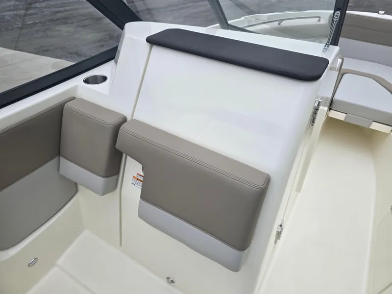 Slide: The Image of 2025 Boston Whaler 210 Vantage interior with beige and white seating. - 15
