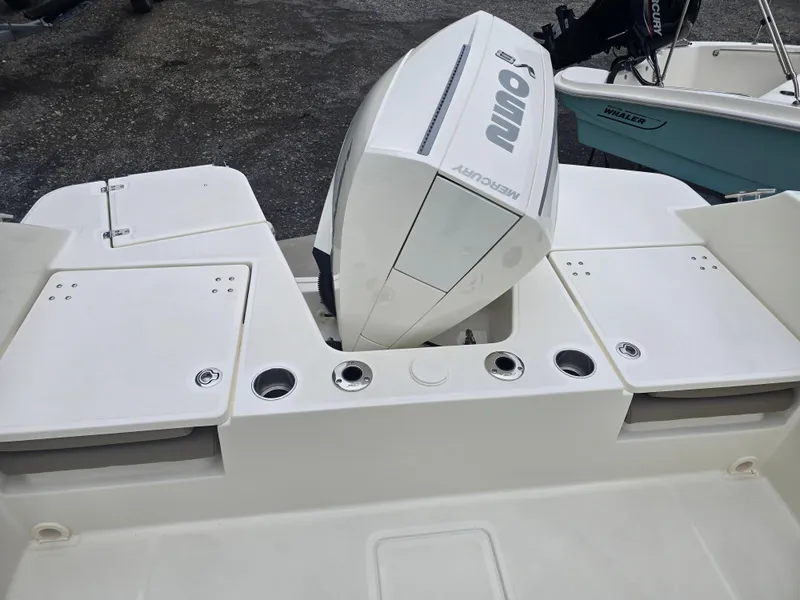 Slide: The Image of 2025 Boston Whaler 210 Vantage boat with Mercury outboard engine, rear deck view. - 24