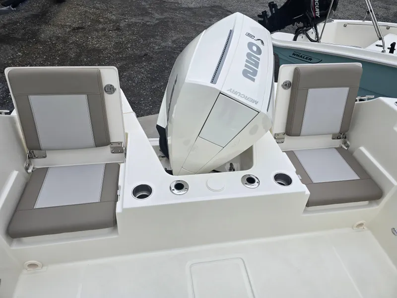 Slide: The Image of 2025 Boston Whaler 210 Vantage boat with dual seating and outboard motor. - 25