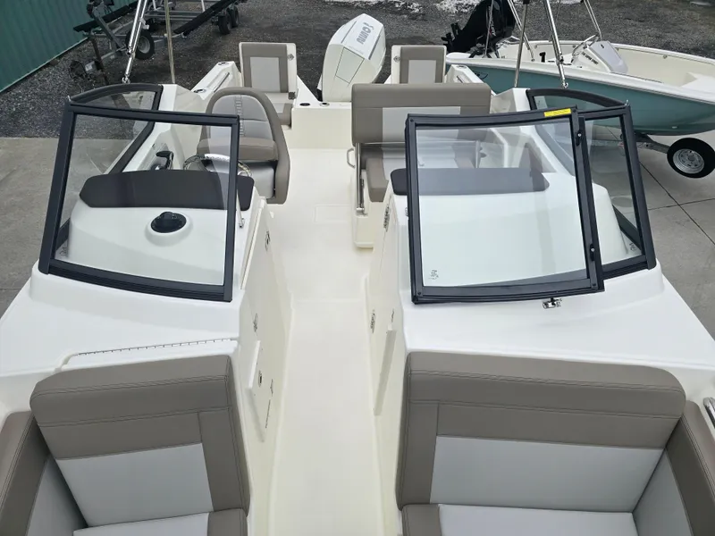 Slide: The Image of 2025 Boston Whaler 210 Vantage boat interior with seating and windshield. - 26