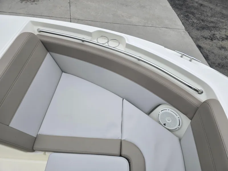 Slide: The Image of 2025 Boston Whaler 210 Vantage boat interior with cushioned seating and speaker. - 28