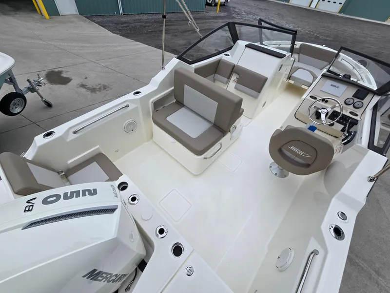 Slide: The Image of 2025 Boston Whaler 210 Vantage boat interior with seating and control panel. - 29