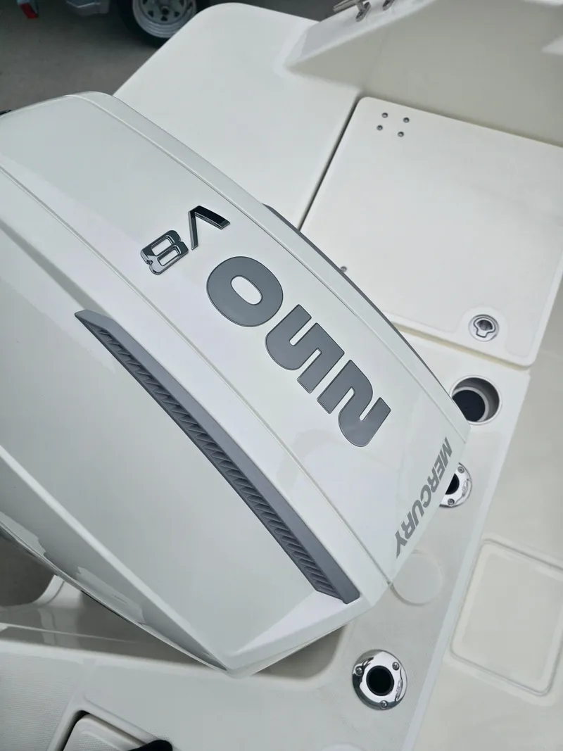 Slide: The Image of 2025 Boston Whaler 210 Vantage with Mercury outboard engine, close-up view. - 9