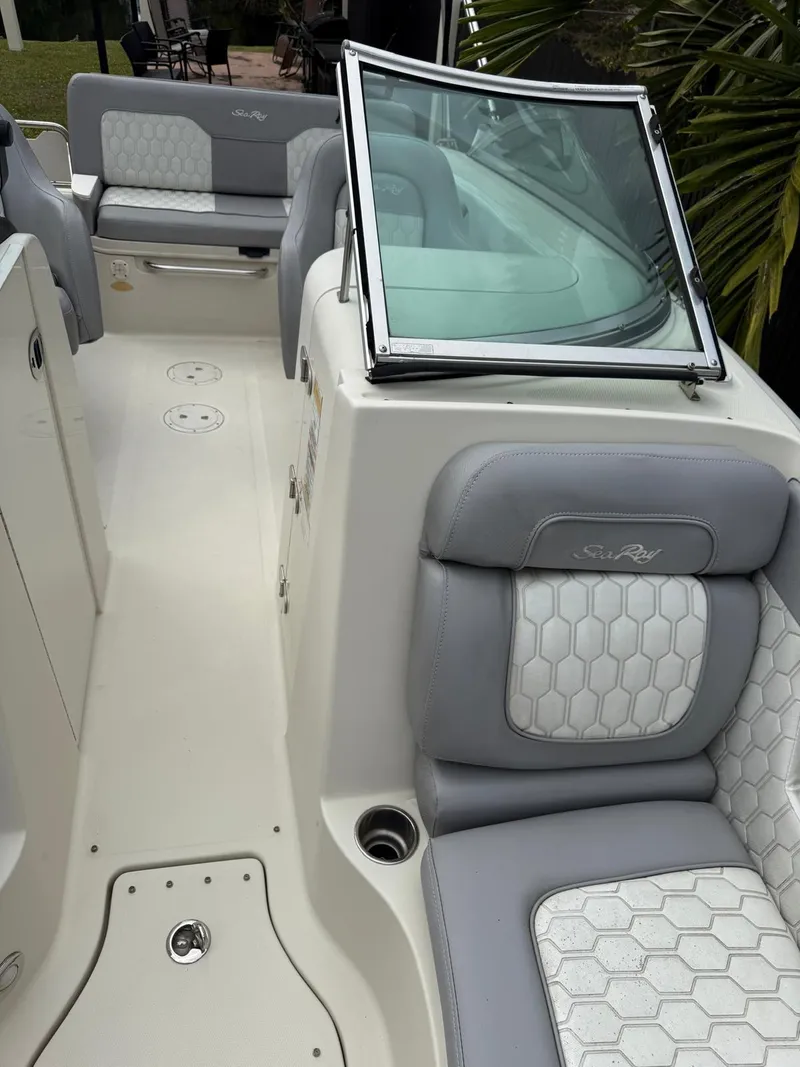 Slide: The Image of 2010 Sea Ray 220 Sundeck interior with gray and white seating, open deck layout. - 4