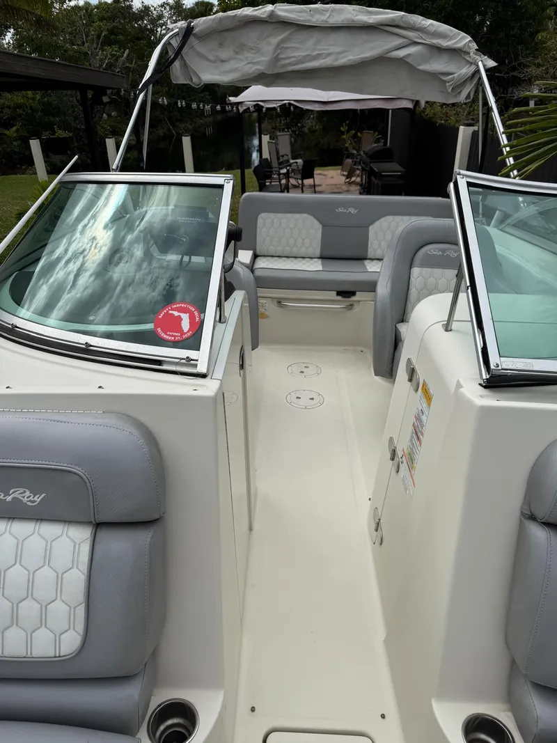 Slide: The Image of 2010 Sea Ray 220 Sundeck boat interior with gray seating and open deck. - 5