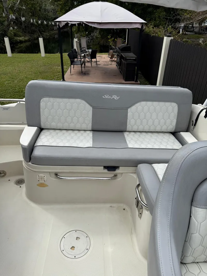 Slide: The Image of 2010 Sea Ray 220 Sundeck boat interior with gray and white seating. - 8