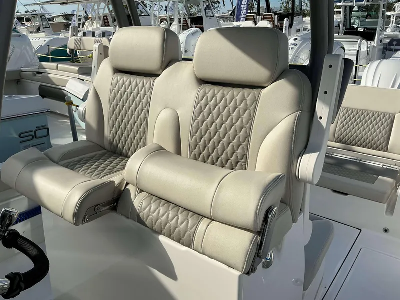 Slide: The Image of Luxurious seating on 2025 Solace 28 HCS boat, featuring diamond-stitched upholstery. - 12