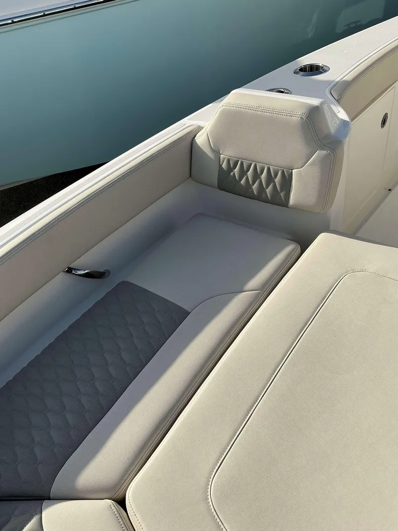 Slide: The Image of 2025 Solace 28 HCS boat interior with cushioned seating and elegant design. - 14