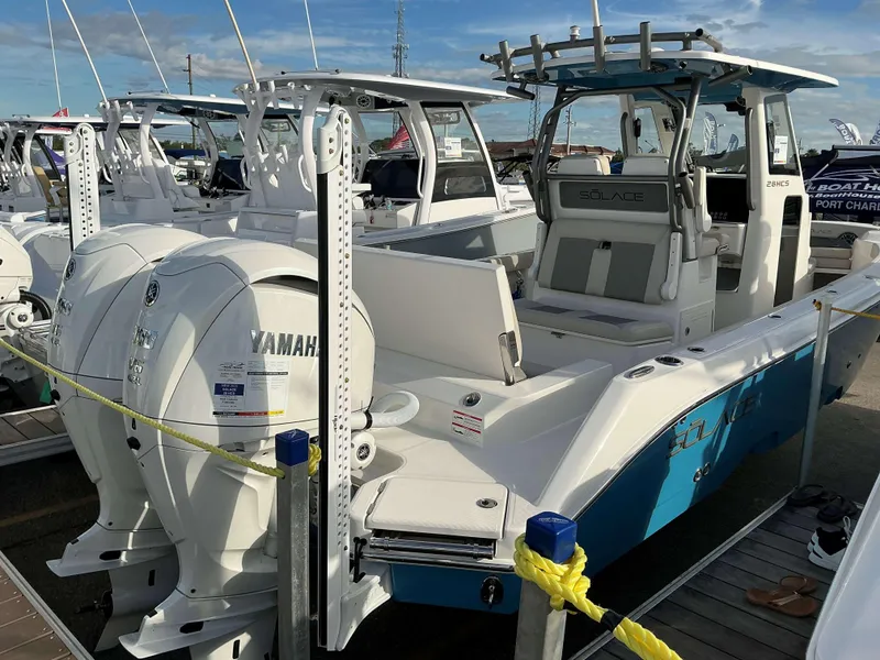 Slide: The Image of 2025 Solace 28 HCS boat with Yamaha engines docked at a marina. - 4