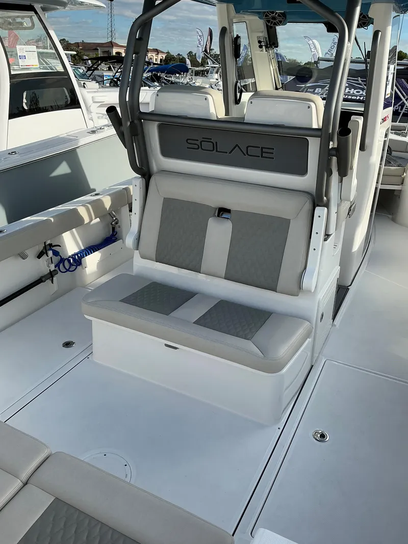 Slide: The Image of 2025 Solace 28 HCS boat interior with cushioned seating and modern design. - 8