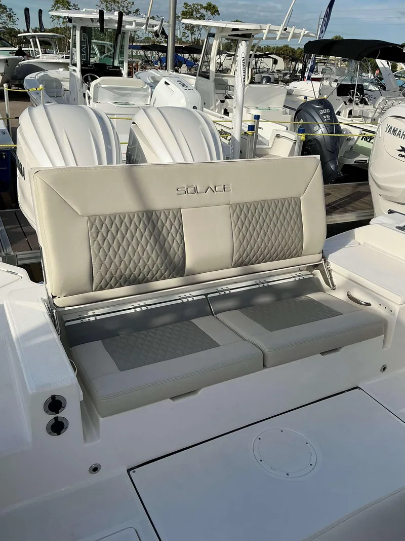 Slide: The Image of 2025 Solace 28 HCS boat seating with dual engines in a marina setting. - 9