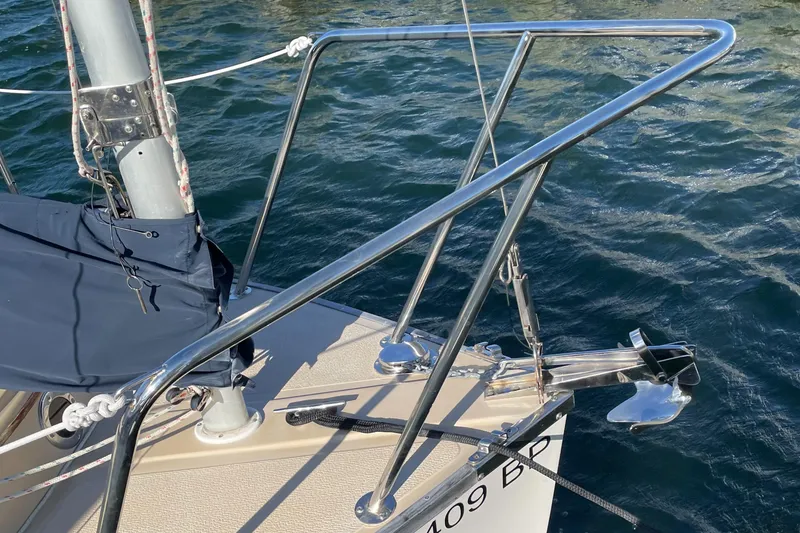 Slide: The Image of 2004 Com-Pac 17 Suncat sailboat bow with anchor and railing on water. - 4