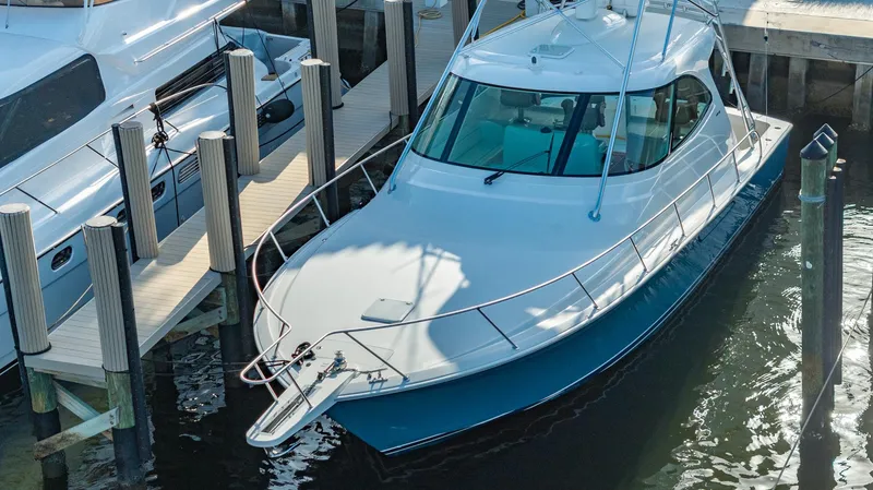 Slide: The Image of 2014 Viking Sport Tower yacht docked at marina, viewed from above. - 3
