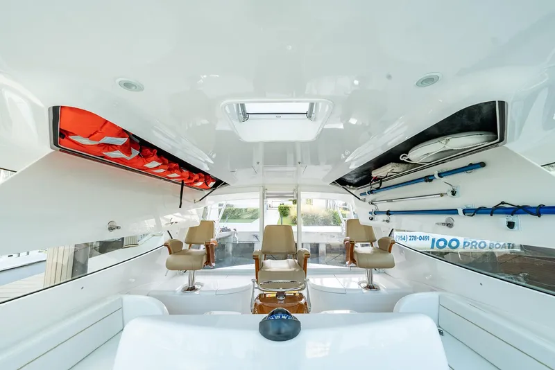 Slide: The Image of 2014 Viking Sport Tower interior with seating, fishing gear, and life jackets. - 30