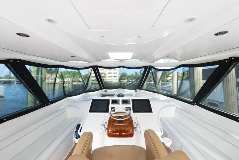 Slide: The Image of 2014 Viking Sport Tower yacht interior with panoramic windows and modern dashboard. - 36