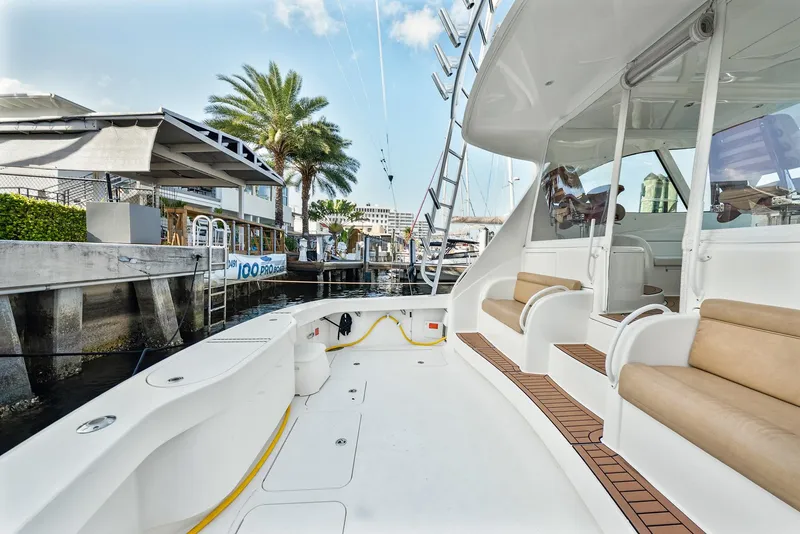 Slide: The Image of 2014 Viking Sport Tower yacht docked, featuring spacious deck and seating area. - 8