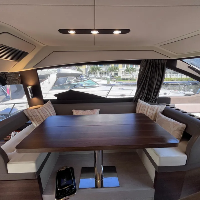 Slide: The Image of Interior of 2015 Azimut 50 Fly yacht with elegant dining area and large windows. - 12