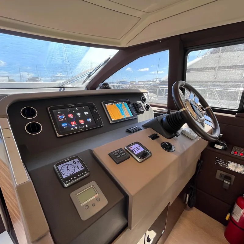 Slide: The Image of Interior helm of 2015 Azimut 50 Fly yacht with navigation equipment and steering wheel. - 13