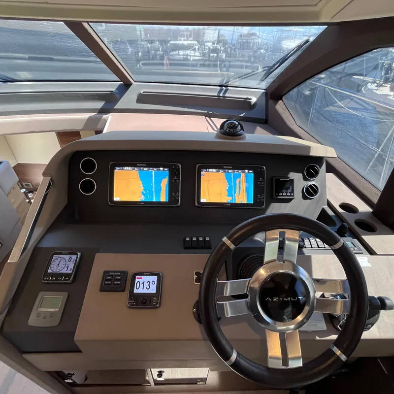Slide: The Image of Cockpit of 2015 Azimut 50 Fly yacht with navigation screens and steering wheel. - 14