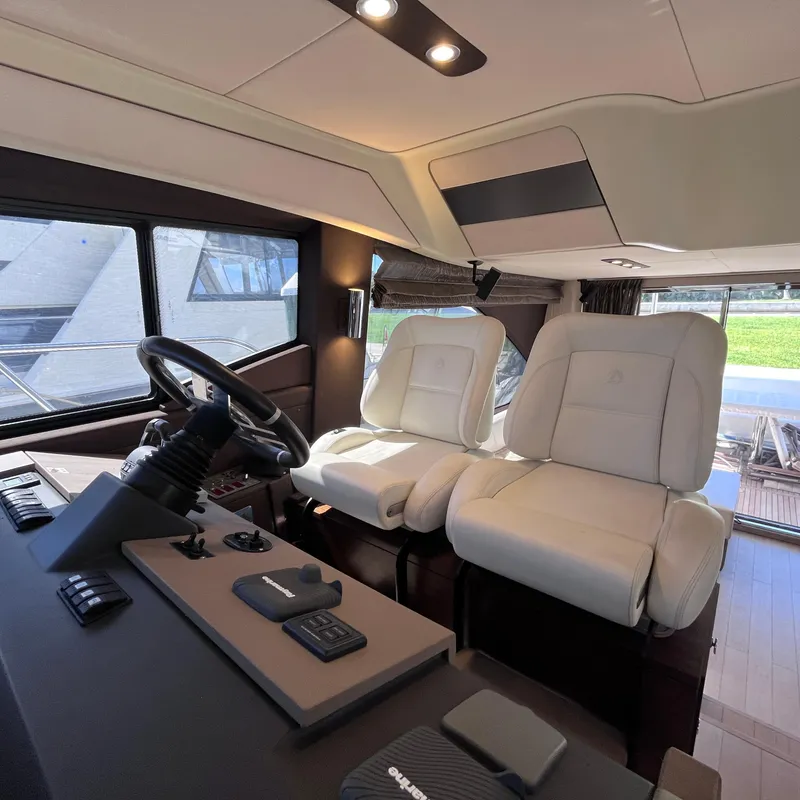 Slide: The Image of Interior of 2015 Azimut 50 Fly yacht with luxurious white seating and modern controls. - 15