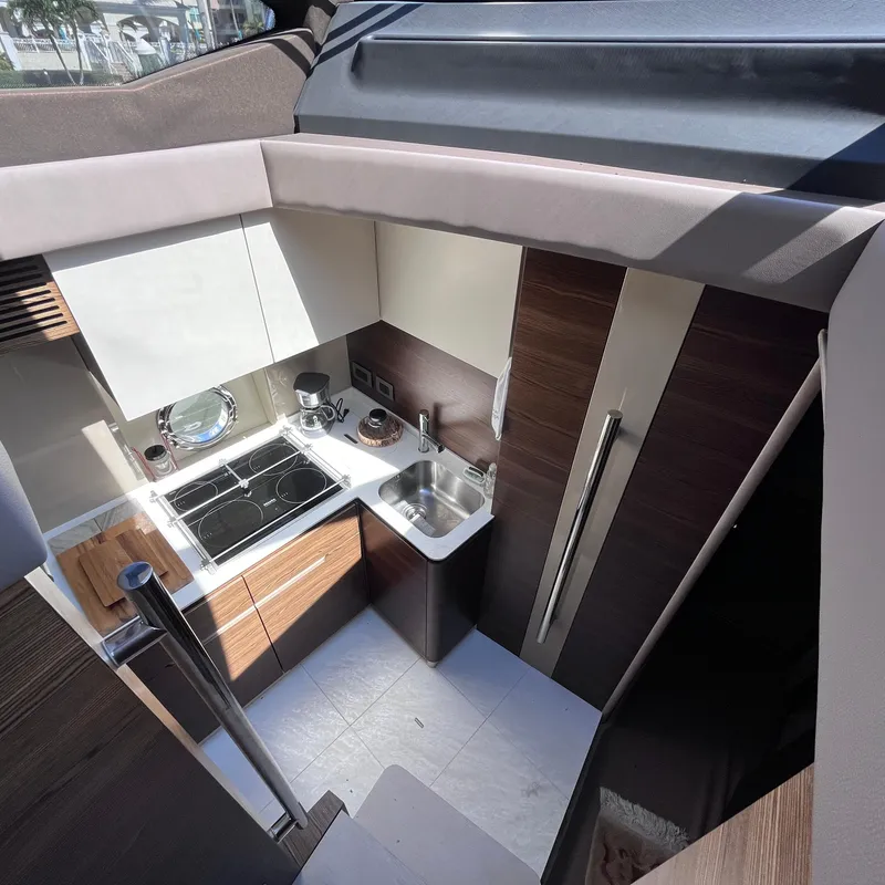 Slide: The Image of Modern kitchen interior of 2015 Azimut 50 Fly yacht, featuring sleek cabinetry and appliances. - 16