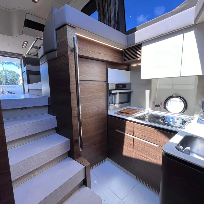 Slide: The Image of Luxurious interior of 2015 Azimut 50 Fly yacht, featuring modern kitchen and staircase. - 17