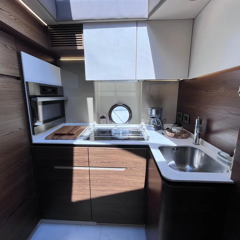Slide: The Image of Modern kitchen interior on 2015 Azimut 50 Fly yacht, featuring sleek cabinetry and appliances. - 18