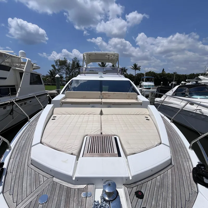 Slide: The Image of Azimut 50 Fly 2015 yacht with spacious deck under a partly cloudy sky. - 2