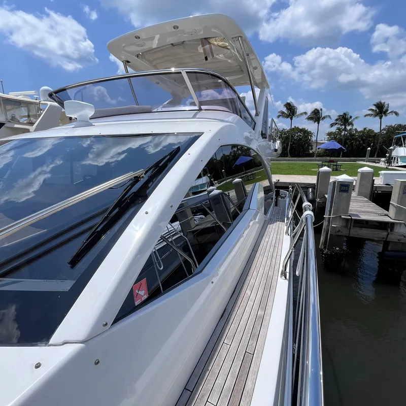 Slide: The Image of Azimut 50 Fly 2015 yacht docked, showcasing sleek design and luxurious features under a sunny sky. - 3