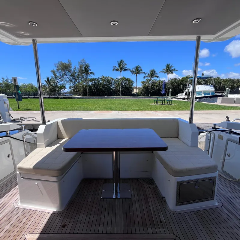 Slide: The Image of Azimut 50 Fly 2015 yacht deck with seating area and table, overlooking marina. - 32