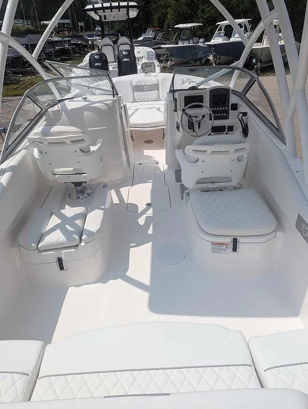 Slide: The Image of 2025 Sea Fox 228 Traveler boat interior with white seating and modern dashboard. - 11