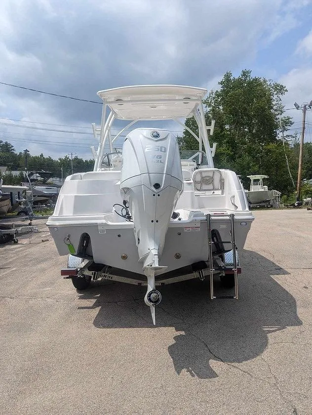 Slide: The Image of 2025 Sea Fox 228 Traveler boat with outboard motor, parked outdoors. - 13