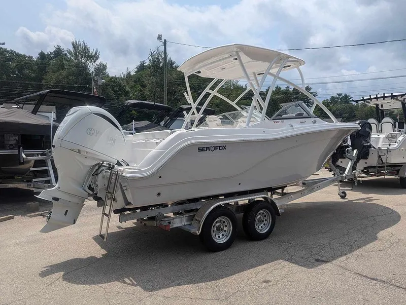 Slide: The Image of 2025 Sea Fox 228 Traveler boat on a trailer, parked outdoors. - 14