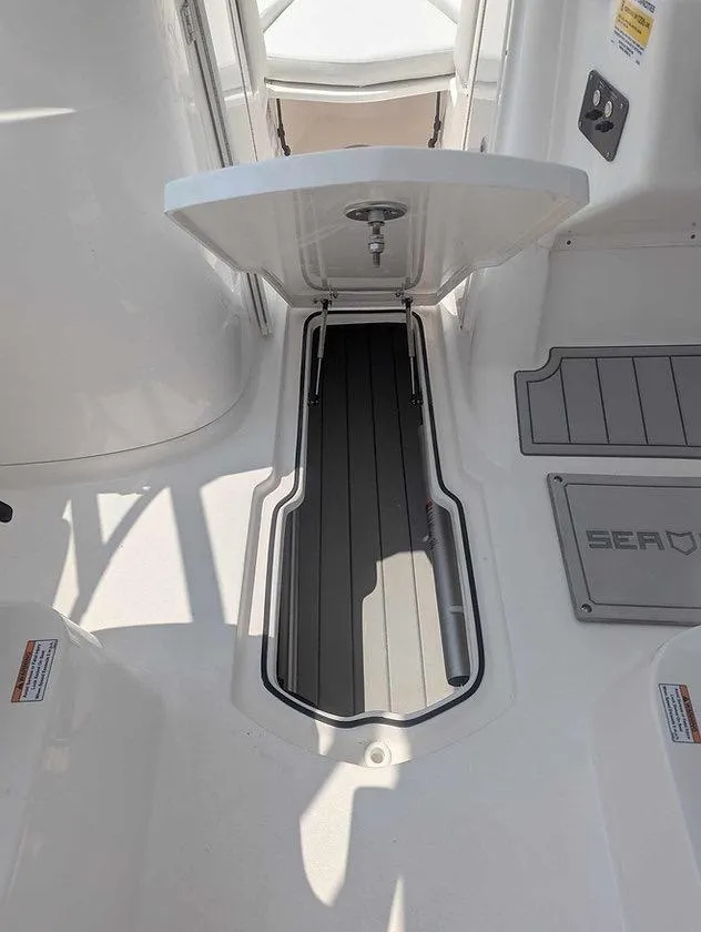 Slide: The Image of 2025 Sea Fox 228 Traveler boat interior with open storage compartment. - 5