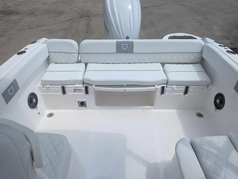 Slide: The Image of 2025 Sea Fox 228 Traveler boat interior with white cushioned seating and speakers. - 7