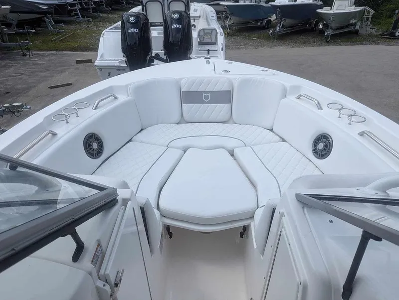 Slide: The Image of 2025 Sea Fox 228 Traveler boat interior with white seating and cup holders. - 9