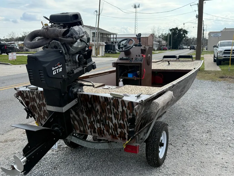 Slide: The Image of 2016 Gator Tail 1648 boat with camo design and GTR motor on a trailer. - 5