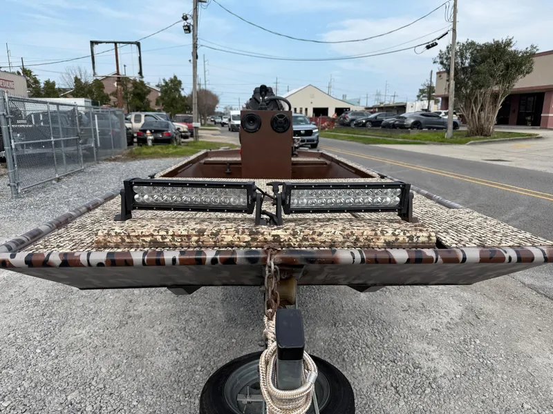 Slide: The Image of 2016 Gator Tail 1648 boat with camouflage pattern and LED lights on a trailer. - 6