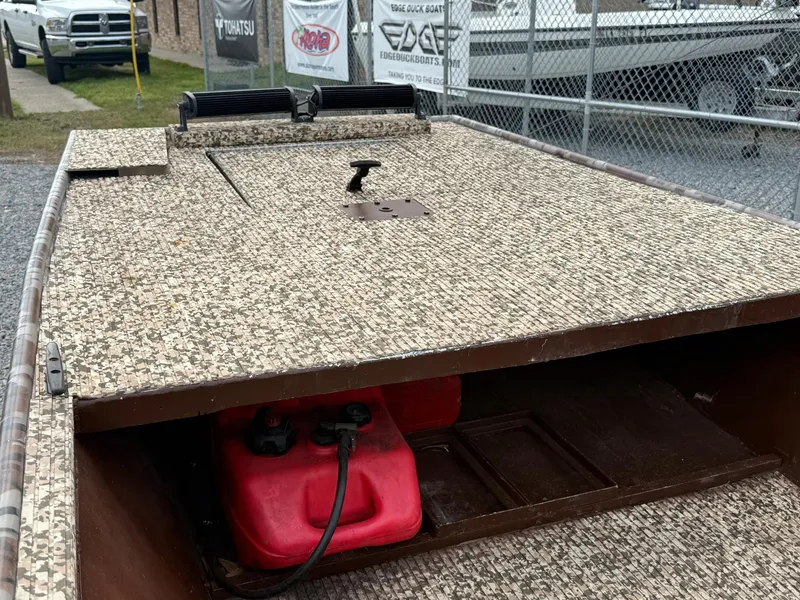 Slide: The Image of 2016 Gator Tail 1648 boat with camo deck and red fuel tank. - 7