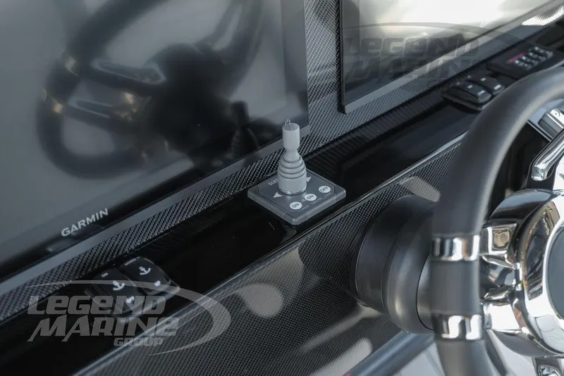 Slide: The Image of Control panel of 2025 Nor-Tech 340 Sport boat with Garmin display and Legend Marine branding. - 14