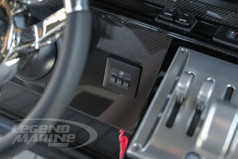 Slide: The Image of Control panel of 2025 Nor-Tech 340 Sport boat with switches and safety lanyard. - 17