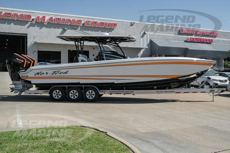 Slide: The Image of 2025 Nor-Tech 340 Sport boat on trailer, featuring triple outboard engines. - 3