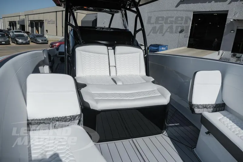Slide: The Image of 2025 Nor-Tech 340 Sport boat with sleek seating and modern design in a marina setting. - 30