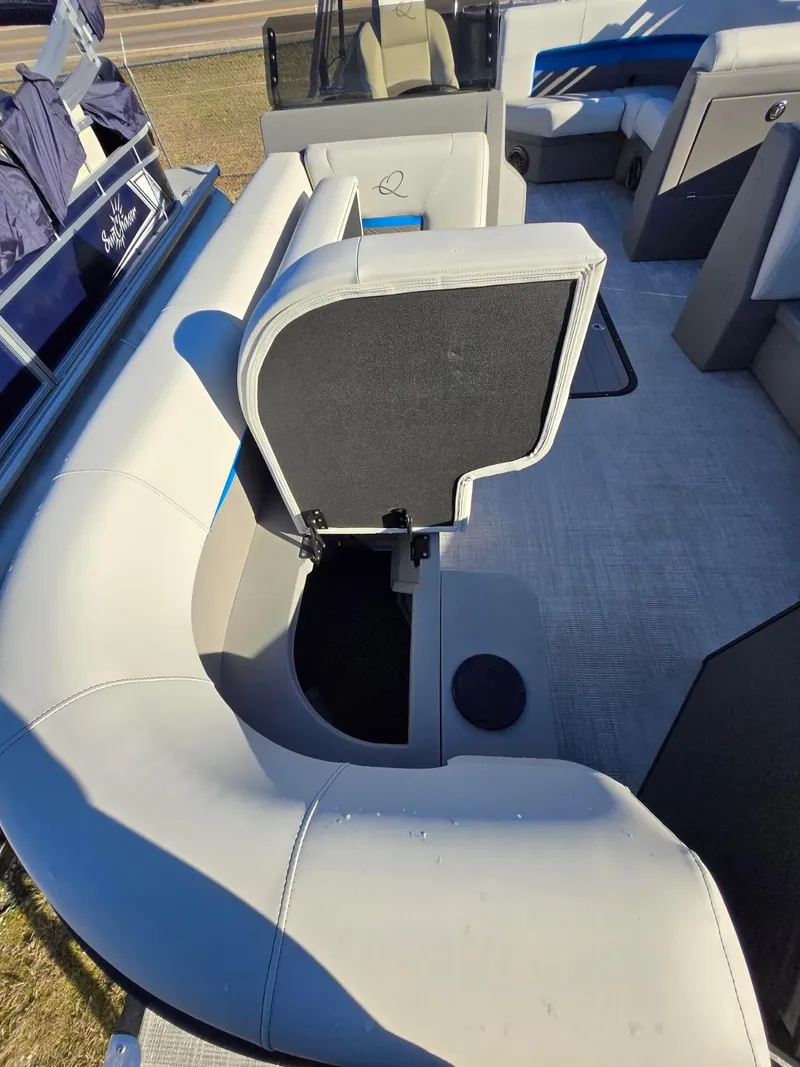 Slide: The Image of 2025 Qwest E-CLASS 22 XRE CRUISE boat interior with seating and storage compartment. - 10