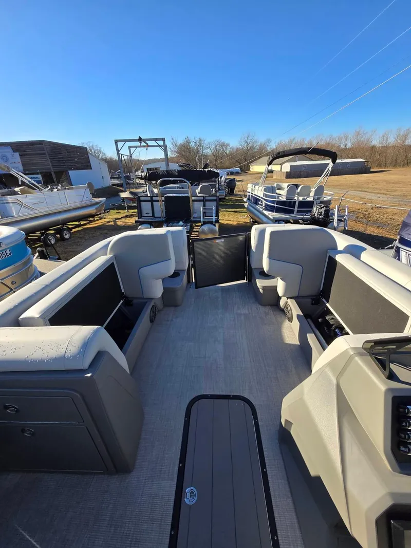 Slide: The Image of 2025 Qwest E-CLASS 22 XRE CRUISE pontoon boat interior with seating and console. - 12