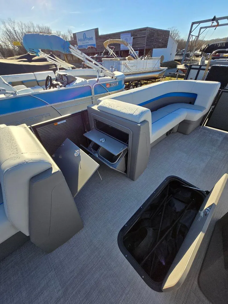 Slide: The Image of 2025 Qwest E-CLASS 22 XRE CRUISE boat interior with seating and storage compartments. - 13