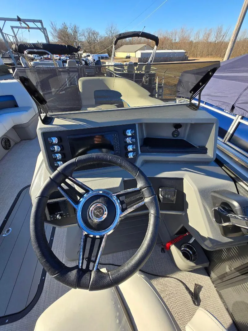 Slide: The Image of 2025 Qwest E-CLASS 22 XRE CRUISE boat dashboard with steering wheel and controls. - 14